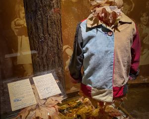 A massive colorful patchwork coat display celebrating Dolly Parton's iconic song, standing along a Pigeon Forge roadside.